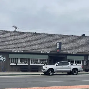 a pickup truck parked in front of a building