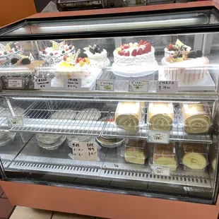 a display case full of cakes and pastries