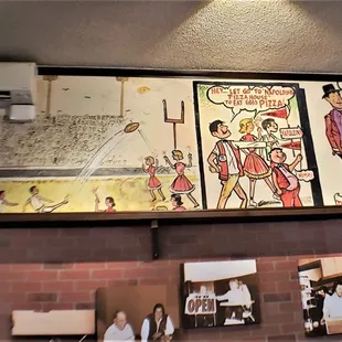 The origin-story artwork on the wall is very charming