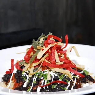 The Napoleon Bowl: Brown rice, black beans, salsa roja, salsa verde, cilantro crema, queso, feta, crispy tortilla strips.  try it w/ steak!