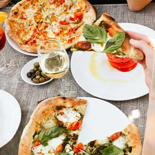 Table spread of summer favs: Summer Love Pie, Green Margherita, and Caprese.