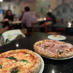 two pizzas on plates
