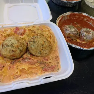 Crab Cake Fettuccine next to giant meatballs