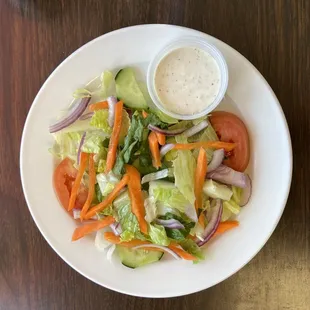 a plate of salad with dressing