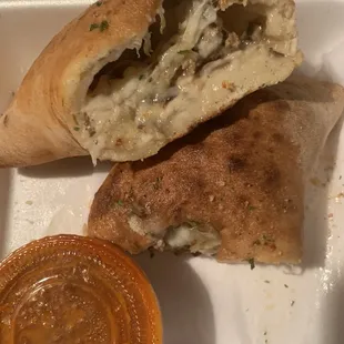 Cross section BYO calzone 5 items (sausage, mushroom, garlic, Canadian bacon and linguica