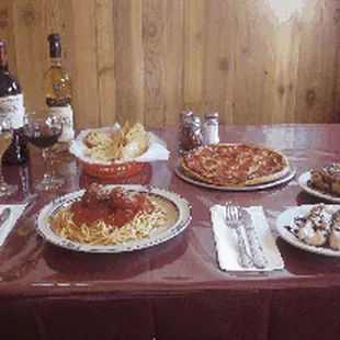 a table setting with wine and food