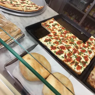 a variety of pizzas on display