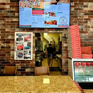 June 2021: The wall menu above the ordering/pickup counter. That's Owner Sam in the background
