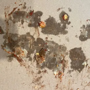 a piece of pizza left on the floor