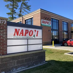 a red car parked in front of the restaurant