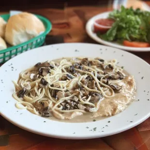 Chicken Marsala: chicken salted with mushrooms in a rich marsala wine sauce and mozzarella cheese served over spaghetti pasta