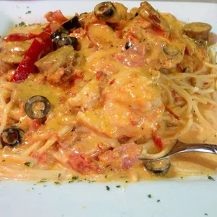 Napolis Special! chicken, sausage and ham served with black olives, red peppers and spaghetti, made with creamy alla panna sauce