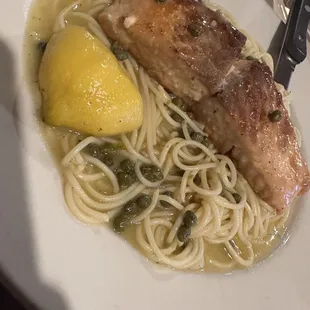 a plate of pasta with chicken and lemon