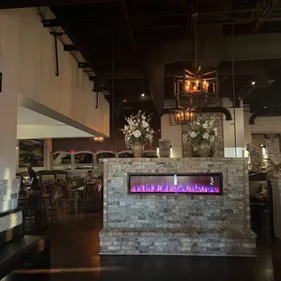 a fireplace in the middle of the restaurant