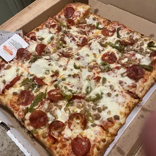 Sicilian pizza with sausage, pepperoni, green peppers and onions.