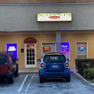 two cars parked in front of the restaurant