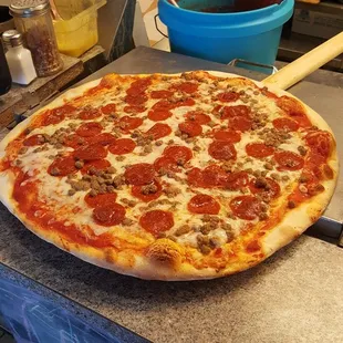 a pepperoni pizza sitting on a counter
