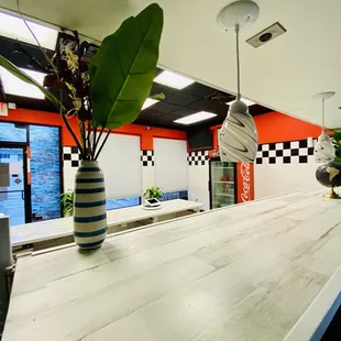 a counter with a vase of flowers on it