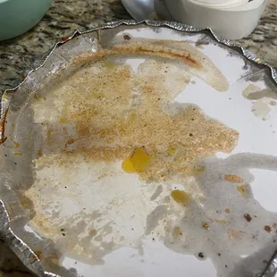 Cover of lasagna dish with grease soaking through.