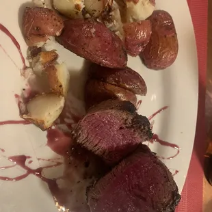 a plate of meat and potatoes