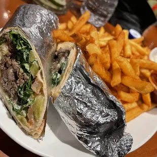 a burrito and french fries on a plate