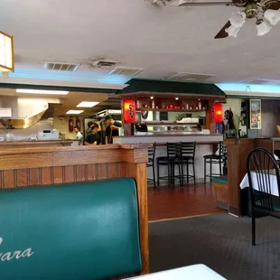 Front of the restaurant with the &quot;sushi bar&quot;, register, and view into the kitchen.