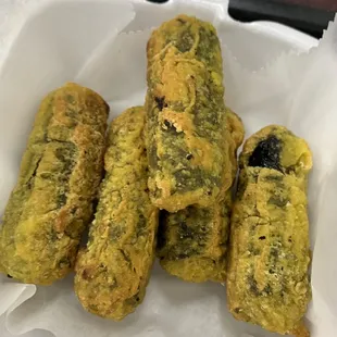 Fried rolls. Kinda look like little pickles, but they are rice and veggies rolled up in seaweed, then fried.