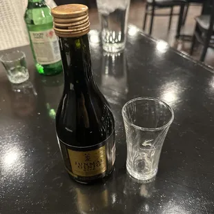 a bottle and a shot glass
