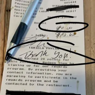 a note with a pen on it