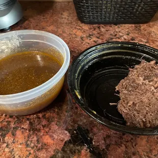 a hamburger and a bowl of sauce
