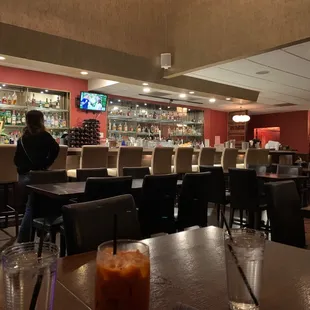 a woman standing at the bar