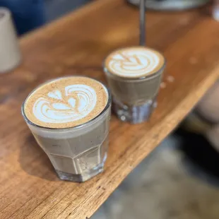 two cups of coffee on a wooden table