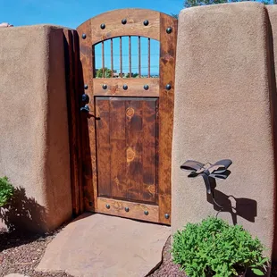 Pine entry gate with copper rod window and calvos.