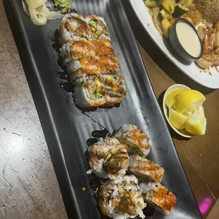 a plate of sushi and a plate of vegetables