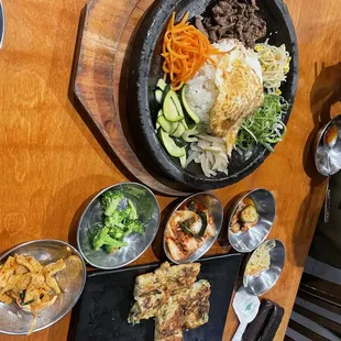 Bibimbap and sides. Half eaten seafood pancake.