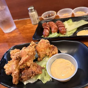 two plates of food with dipping sauce