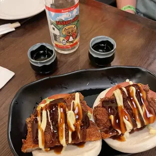 two buns on a black plate