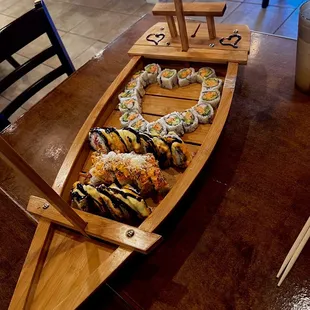 a wooden boat with sushi on it
