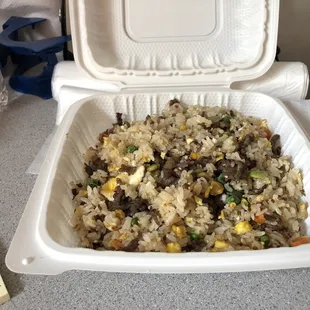 a container of rice and vegetables