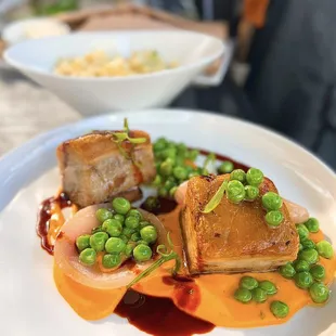 Double Cooked Pork Belly w/ whipped carrots with dill, sweet peas, roasted onion, master jus | $42