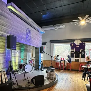 a large room with a stage and several chairs