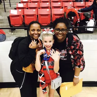 My daughter and her coaches showing on their 1st place rings