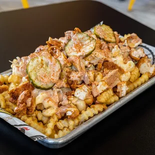 Nash + Tender Fries - Loaded Fries Served w/ Mac N&apos; Cheese, Coleslaw, Pickles, and Special Sauce.