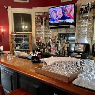 a bar with wine glasses on the counter