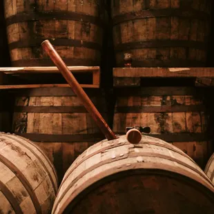 a baseball bat leaning on a barrel