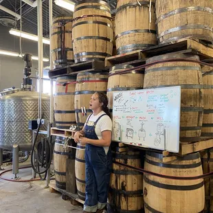 a woman standing in front of barrels