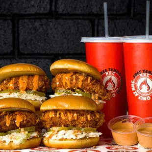 a stack of chicken sandwiches and a drink