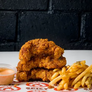 a stack of fried chicken and french fries