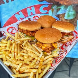 a tray of fries and burgers
