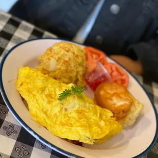 a plate of omelets and tomatoes